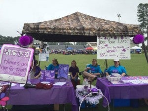 Southampton Middle School’s Relay for Life Team sitting underneath their team tent. -- Walter Francis | Tidewater News