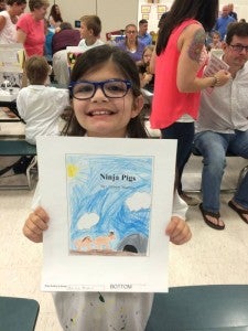 Allison Martins of Windsor Elementary School shows the cover of her story, “Ninja Pigs.” The third grader tells of their origins and battles against evil penguins. She was one of many students who wrote stories that will be published in book form. -- Stephen H. Cowles | Tidewater News