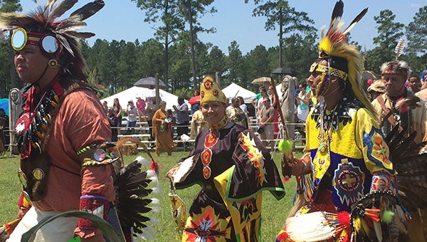 A dancer in her full regalia participates in the Grand Entry at the powwow.