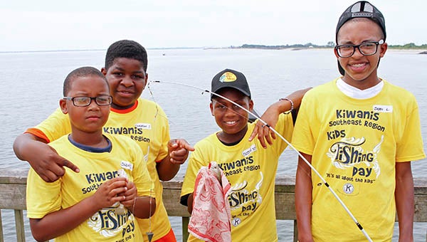 At left are Javon Collins, Quadream Jones and Levintae Brown, who caught the most amount of fish, and at right is Jalin Lashley, who came in second. -- Frank Davis | Tidewater News