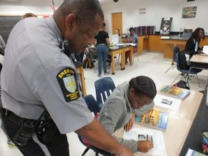 Officer Keith Rose with Zaveona Walton as he patrols and monitors the school and lets his presence be known throughout the walls of Southampton High School.