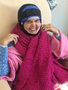 Barbara Herrala of Walters is bundled in pink-colored blankets and scarves while wearing the first in a series of Arctic Cold Caps. -- STEPHEN H. COWLES | The Tidewater news