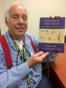Ash Cutchin shows a copy of his first book, “Dog Tails, Fish Tales and Other Misadventures.” He’ll be at the Farmer’s Market in Downtown Franklin on Saturday to sell and autograph some available copies. -- Stephen H. Cowles | Tidewater News